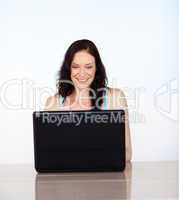 Smiling woman concentrated on her laptop