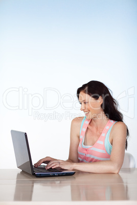 Attractive woman using a laptop with copy-space