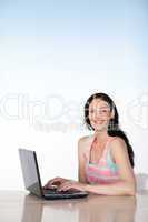 Brunette woman working with a laptop and copy-space