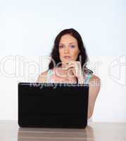 Woman working with her laptop looking at the camera