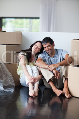 Happy couple in their new house with copy-space