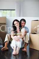 Smiling couple sitting in their new house