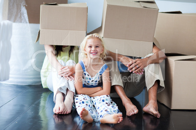 Parents and daughter playing at home with boxes