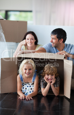 Happy family playing at home with boxes