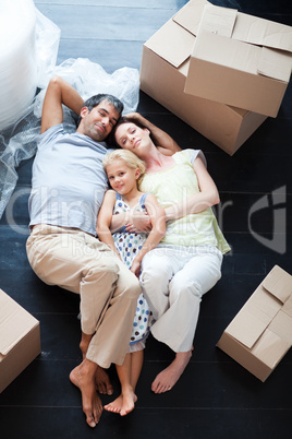 Parents and daughter lying on the floor