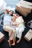 Parents and daughter lying on the floor