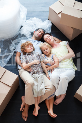 Beautiful family sleeping on the floor