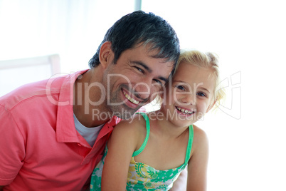 Father and daughter smiling at the camera