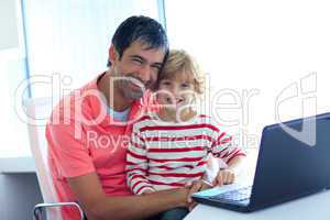 Father and son playing with a laptop