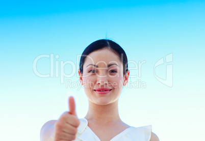 Portrait of a businesswoman outdoors with thumbs up