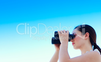 Businesswoman looking through binoculars with copy-space