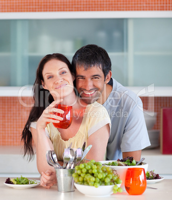 Couple eating and drinking in the kitchen