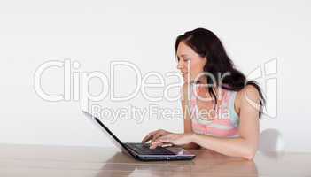 Smiling woman using her laptop with copy-space