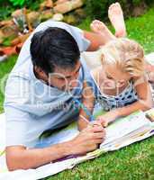 Dad and daughter painting in a garden