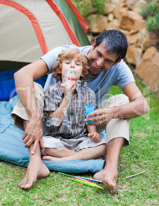 Father and son blowing bubbles