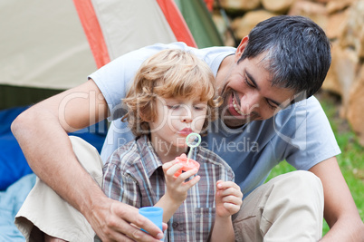 Father and son having fun with bubbles