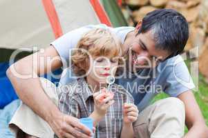 Father and son having fun with bubbles