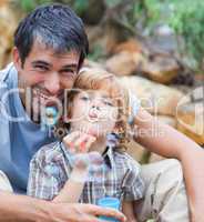 Portrait of a father and son blowing bubbles