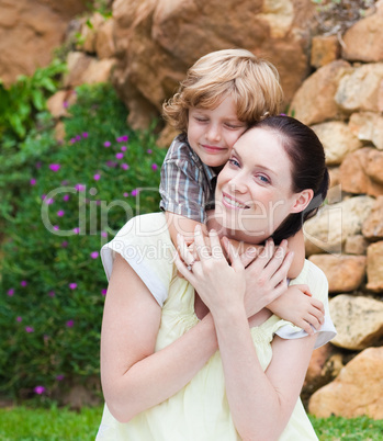 Nice kid embracing his mother