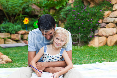 Father and daughter reading in a park