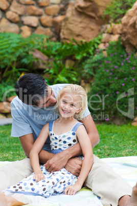 Father playing with his daughter in a garden