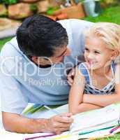 Dad and daughter doing homework in a garden
