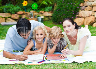 Happy family painting in a garden