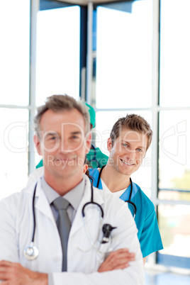 Smiling young doctor in focus in a line with copy-space