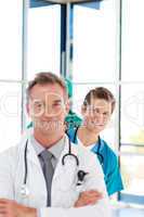 Smiling young doctor in focus in a line with copy-space