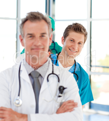 Smiling young doctor in focus in a line