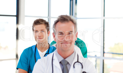 Friendly young doctor in focus in a line