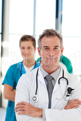 Friendly mature doctor leading his team