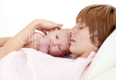 Mother sleeping with her newborn baby