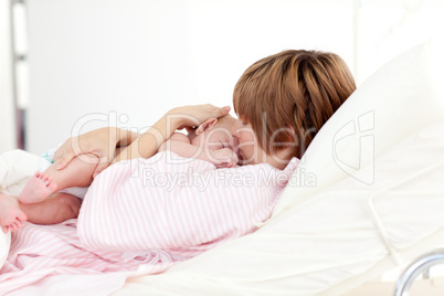 Patient kissing her baby in bed