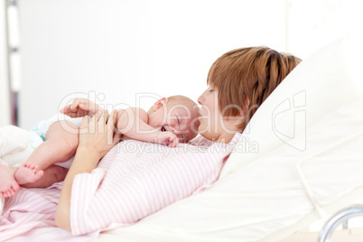 Woman kissing her newborn baby