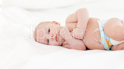 Beautiful baby lying in bed