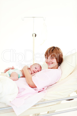 Patient with newborn baby in bed with copy-space