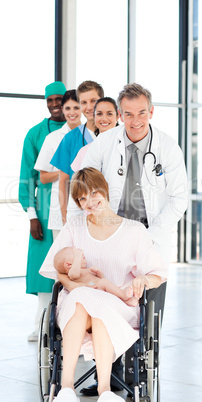 Doctors attending to a patient and her newborn baby