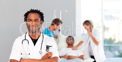 Portrait of an African doctor with a patient in the background
