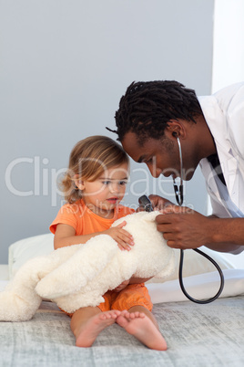 Pediatrician talking to a little girl
