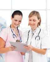 Nurse and doctor reading a medical report
