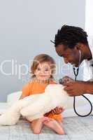 Pediatrician exams a little girl with stethoscope