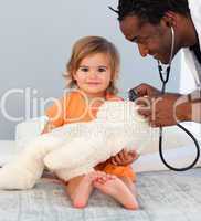 Children's doctor exams a little girl with stethoscope