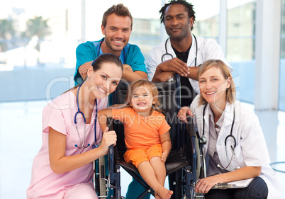 Group of doctors with a little girl in a wheelchair