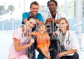 Group of doctors with a little girl in a wheelchair