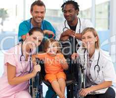 Group of doctors with a baby in a wheelchair