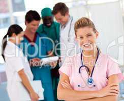 Nurse with doctors in the background