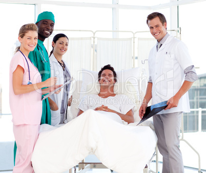 Doctors attending to a patient smiling at the camera