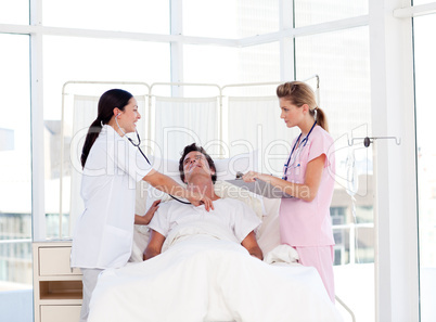 Female doctor and nurse looking after a patient