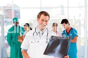 Doctor with colleagues in the background